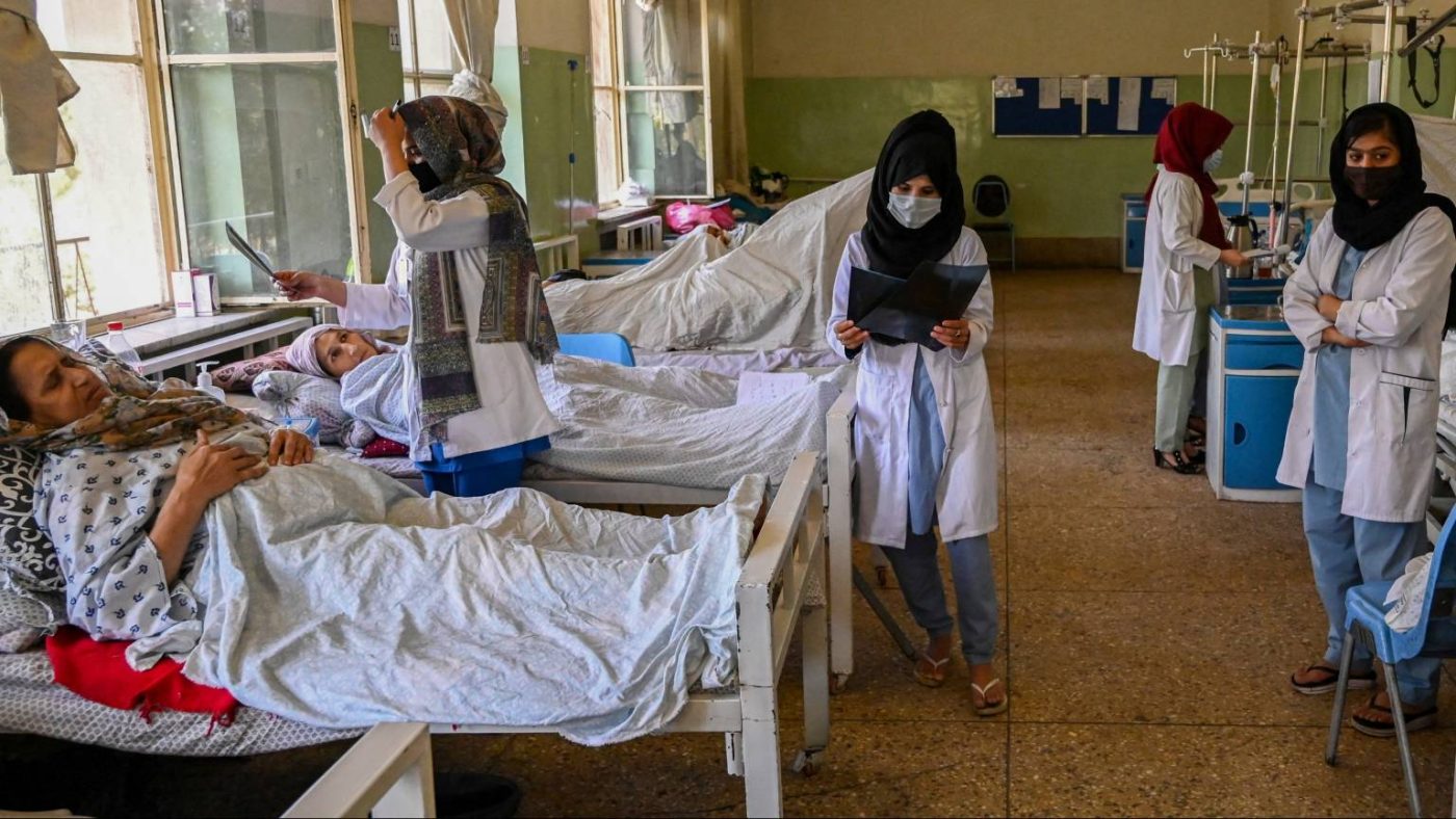 Afghan doctors walking around the hospital between patients
