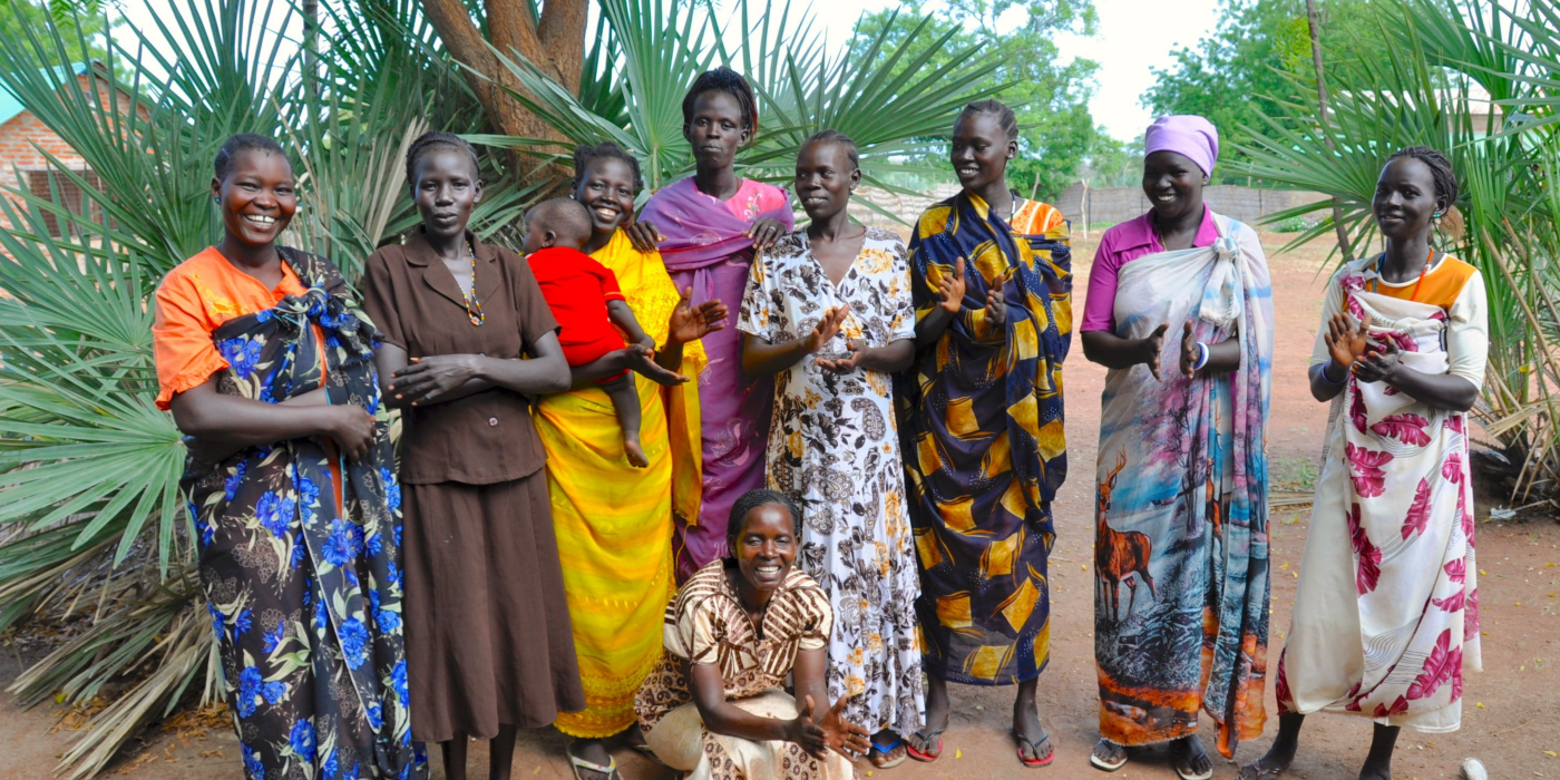 A group of women standing and smiling together