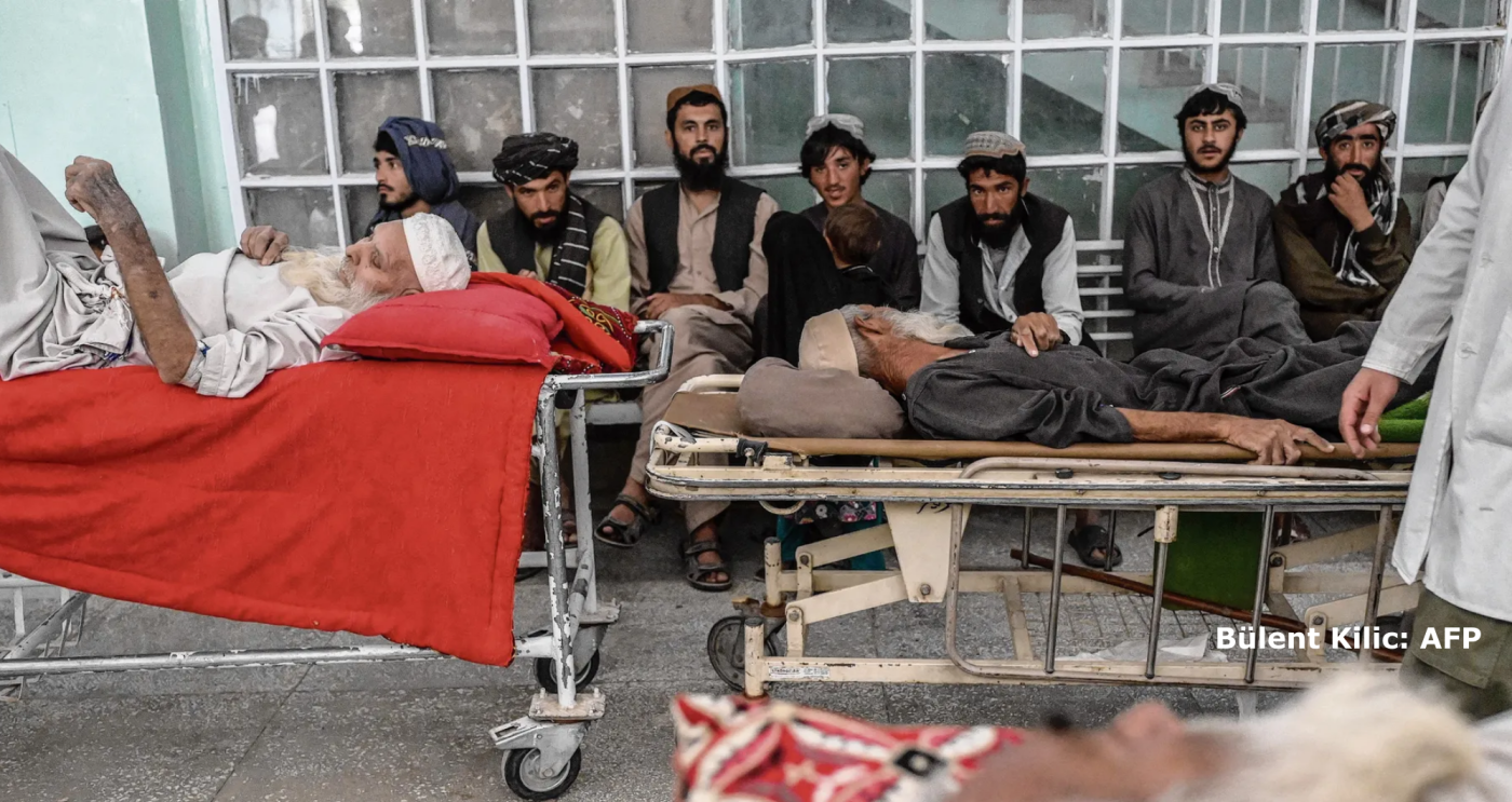 Afghan patients sitting and laying in the waiting room of a hospital