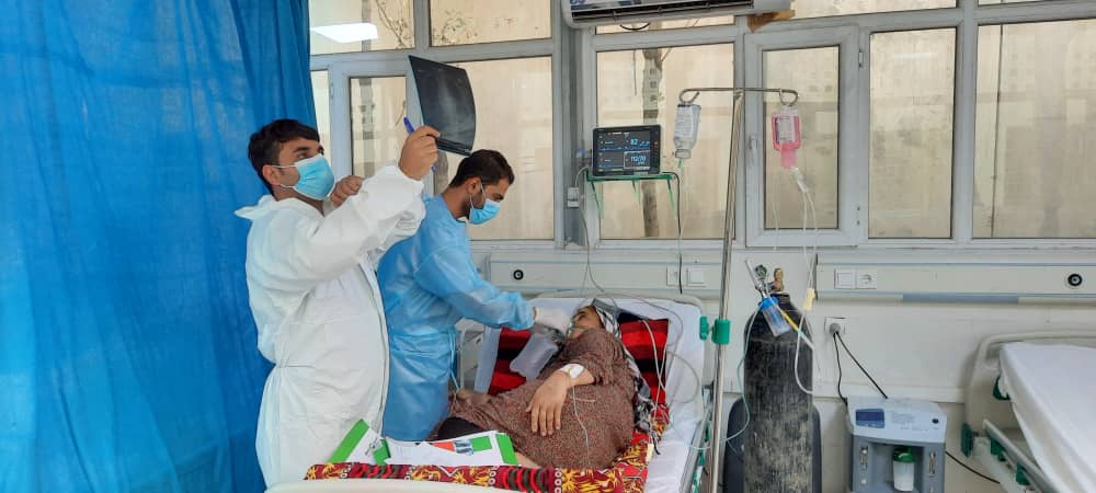 Afghan doctors treating a patient in a hospital