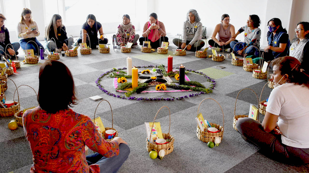 Colombian women sitting in a circle during an event