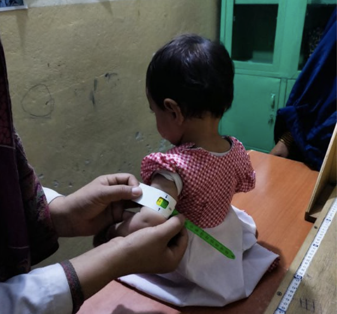 Afghan little girl getting checked by a doctor