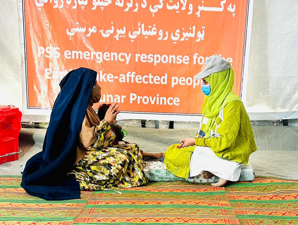 Two Afghan women talk during psycho social support session