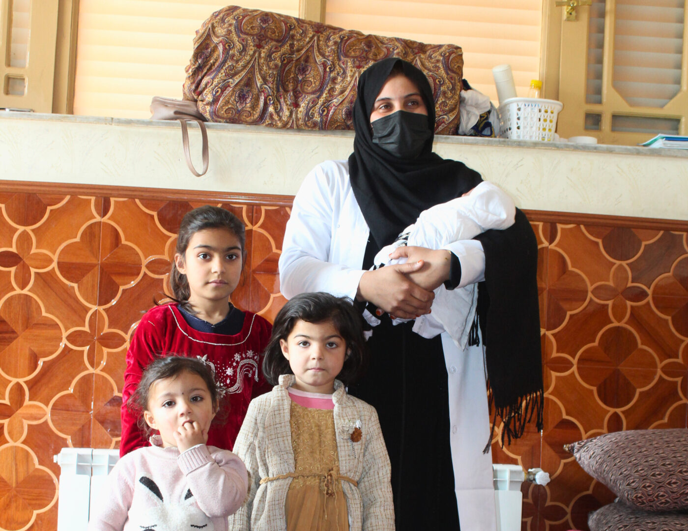Afghan health social counsellor with her children