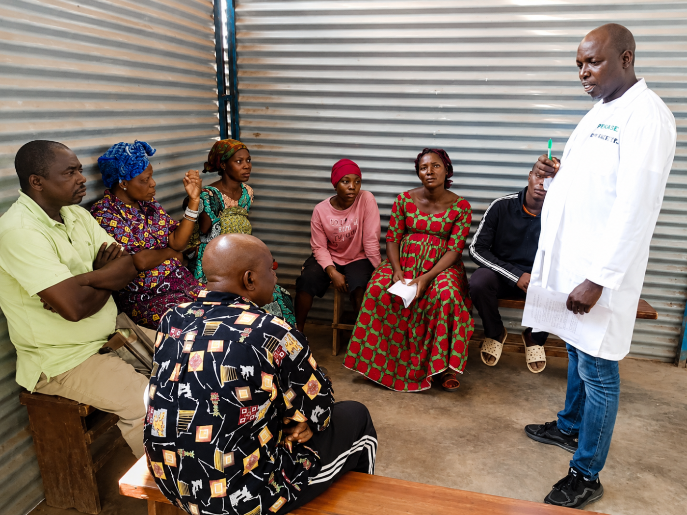 Mental health worker talks with a group of people at a refugee camp in Burundi