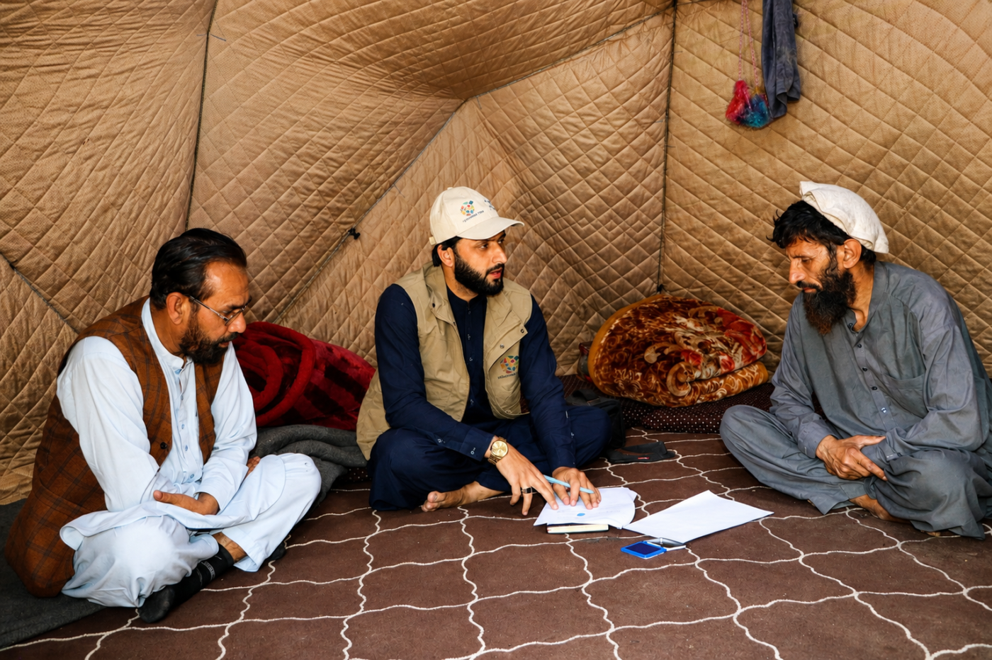 Three men sit together inside a tent in Arrit Valley, Kunar, Afghanistan.