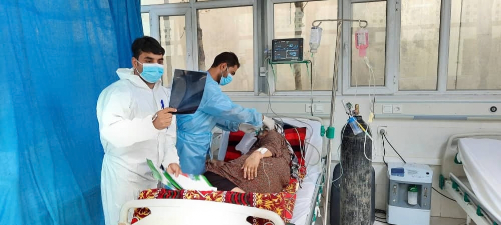 Afghan doctors providing care to hospital patient