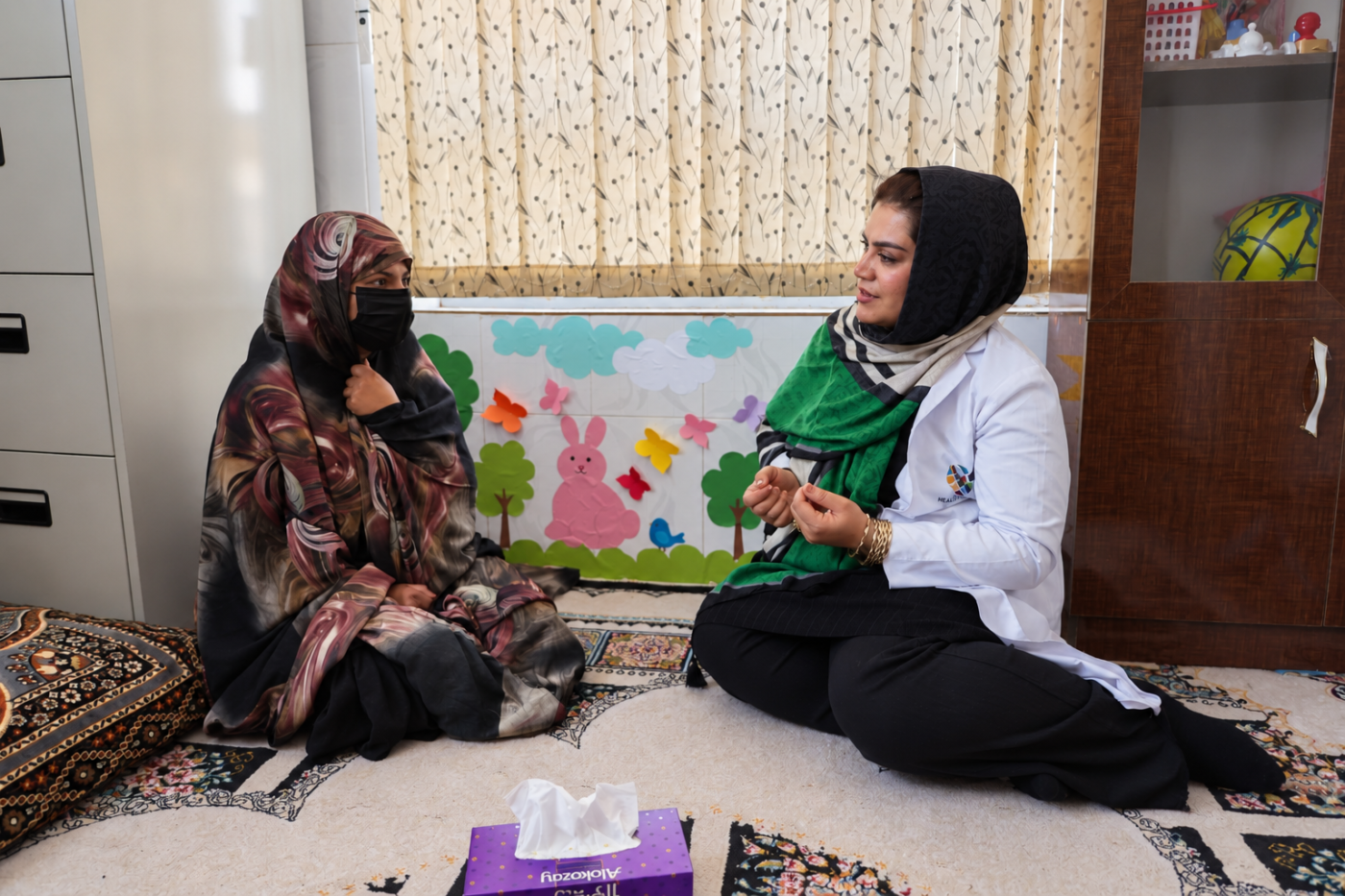 Afghan woman talks to her health social counsellor in Herat