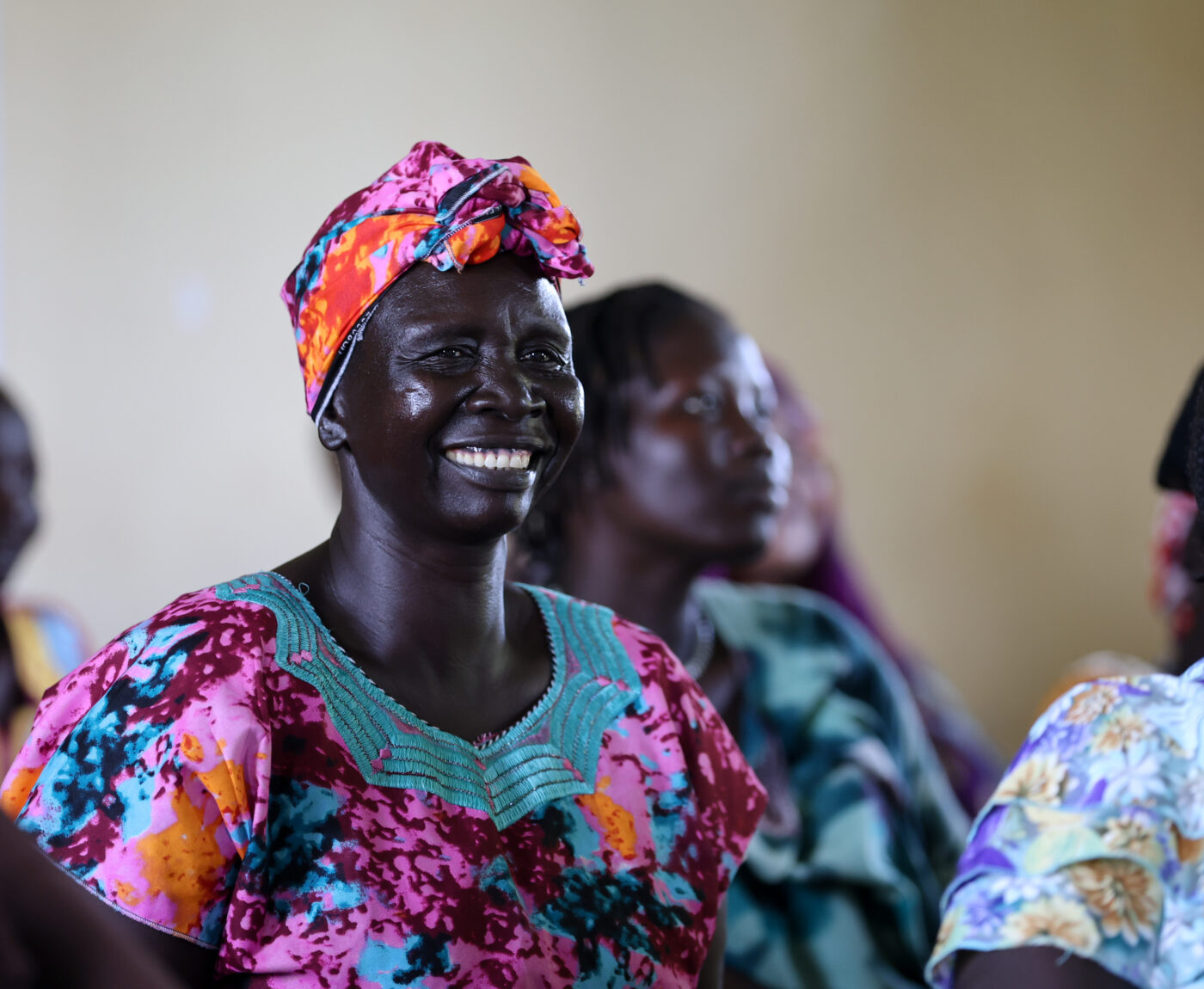 South Sudanese woman with colourful clothes smiling